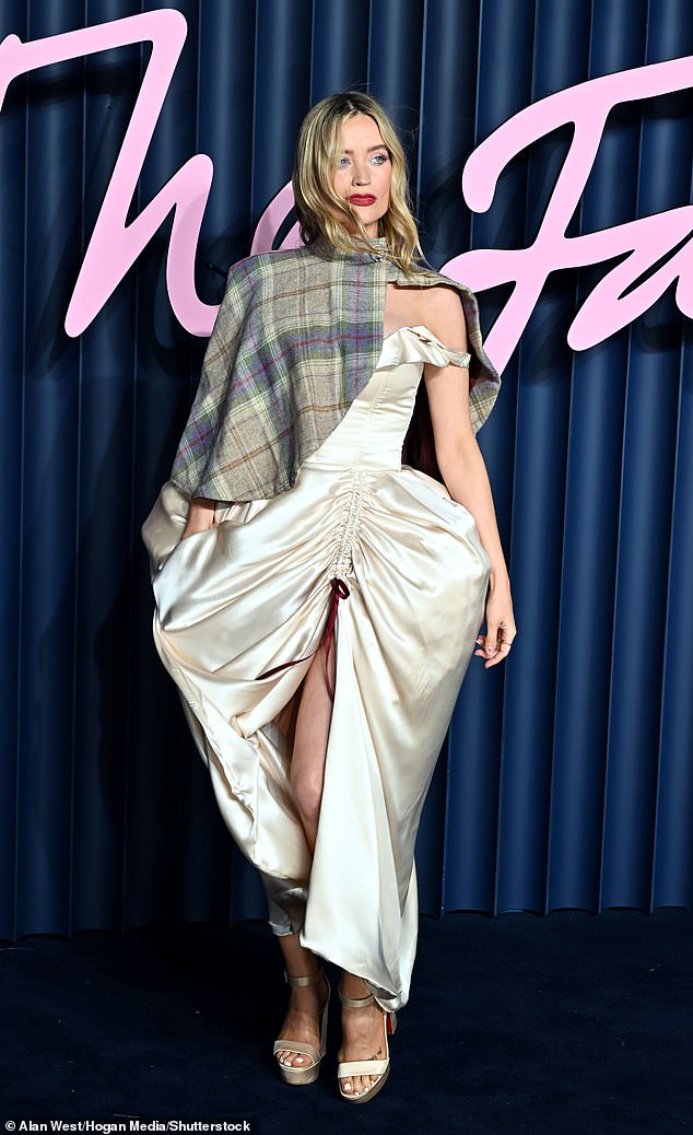 TV presenter Laura also opted for structured hips in an off-the-shoulder gown with a tartan cape