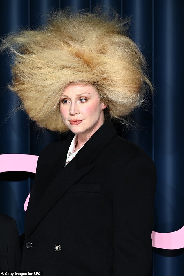 Gwendoline's wig towered above her and swept around her head