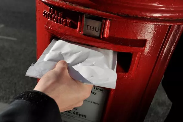 A man posting a letter