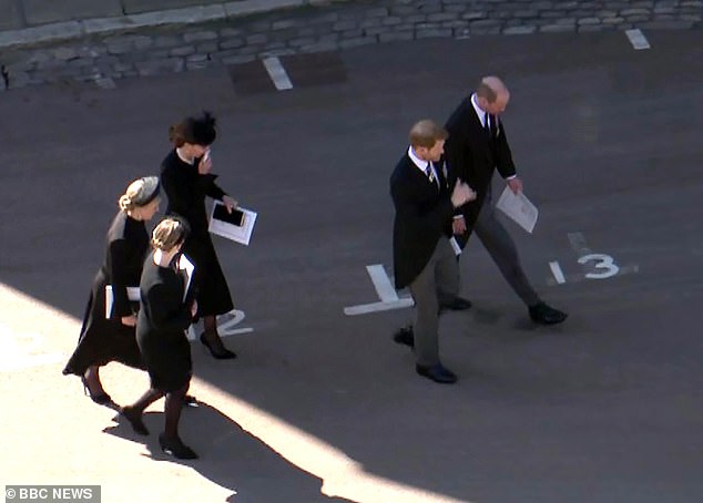 Kate takes a tissue from her handbag after seemingly manoeuvring herself and Harry so he could speak to William alone when leaving the funeral