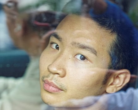Miles Kwan looks towards the camera from inside a car