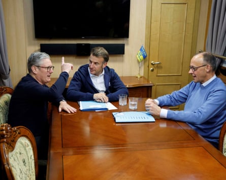 Three men sit at a table.