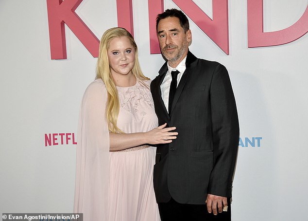 Noticeably missing was Schumer's elusive husband of seven years, Chris Fischer (R, pictured February 3) who, like her, doesn't always wearing his wedding band